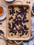 A pan full of the lemon blueberry baked oatmeal, cut into slices