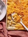 A sheet pan of the chili mac n cheese, with a spoon resting on the tray