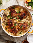 A big pot of the one pan greek chicken and lemon rice, sitting on a countertop